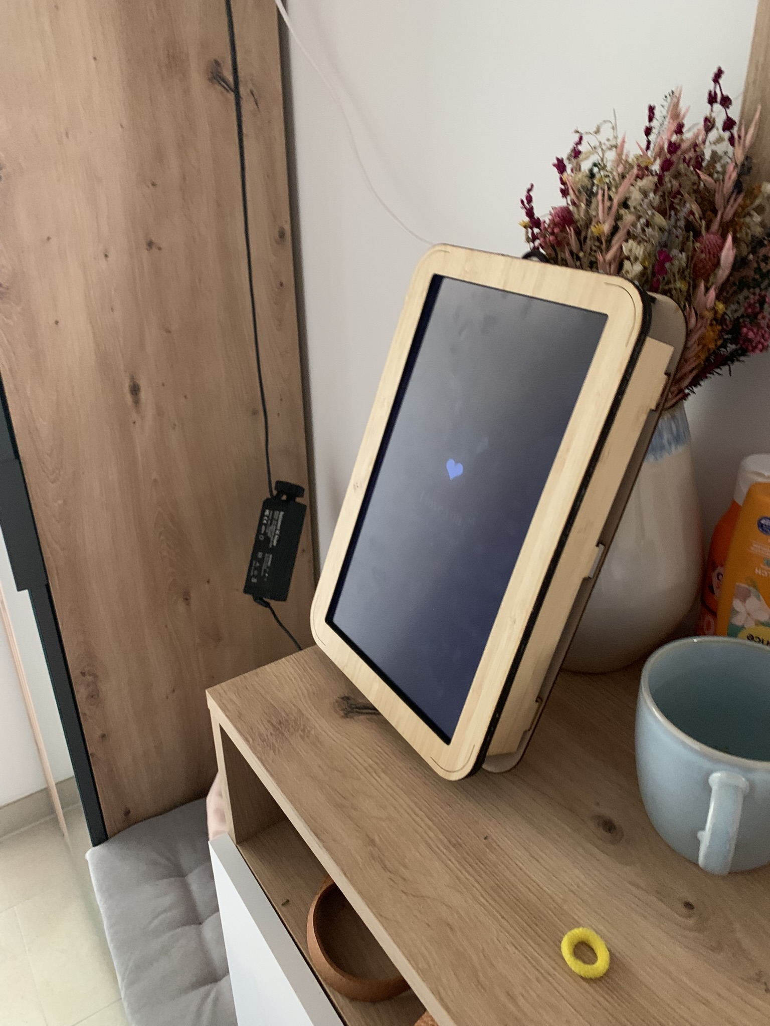Lenovo X201 LCD screen mounted in a laser-cut bamboo wood picture frame, showing a small heart icon on a dark screen